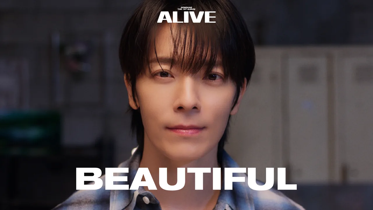Still from the Beautiful music video — DONGHAE close-up under warm light, the album's ALIVE wordmark above